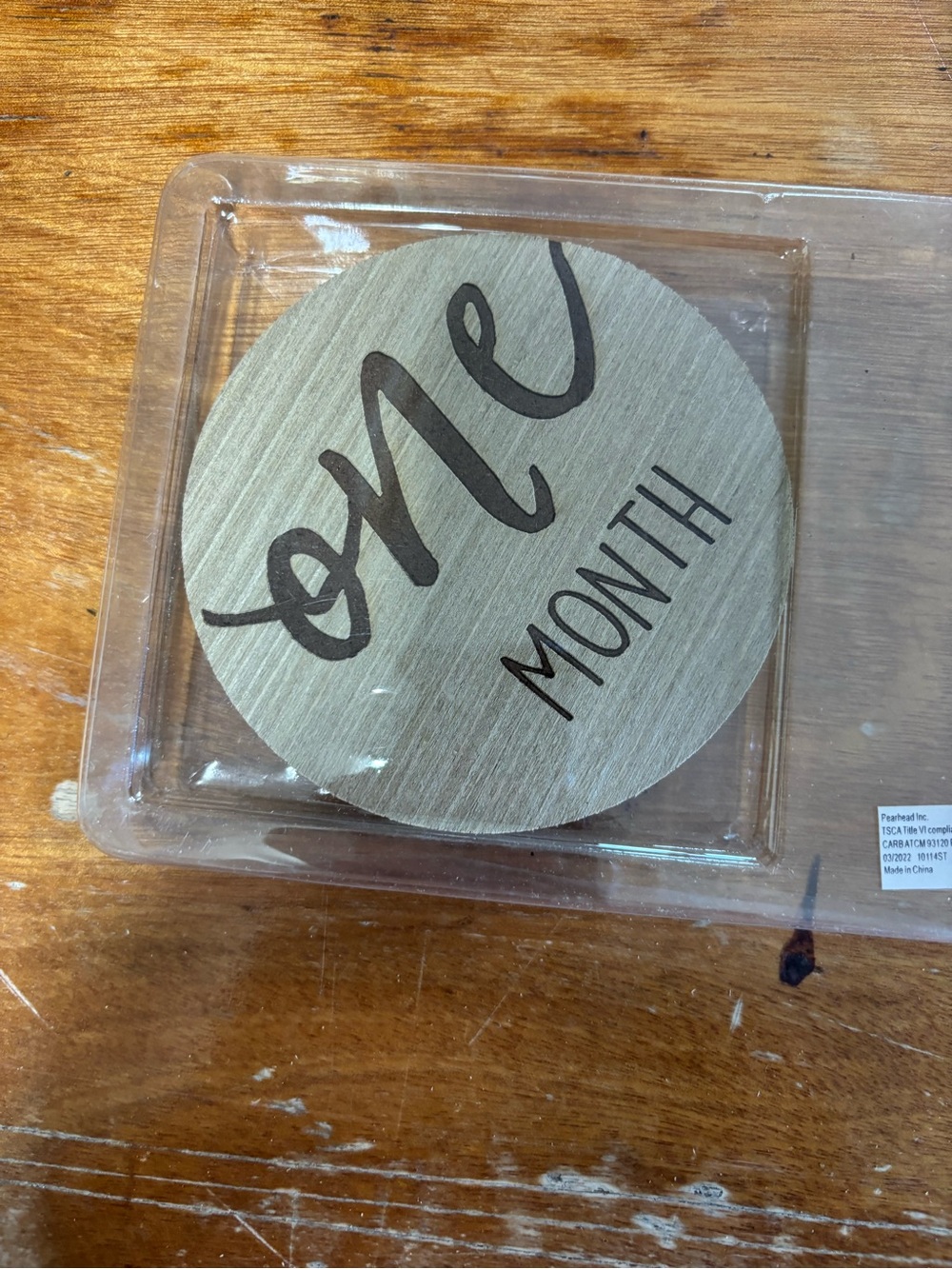 Baby month plates.  Months 1-12 brown with wood background.